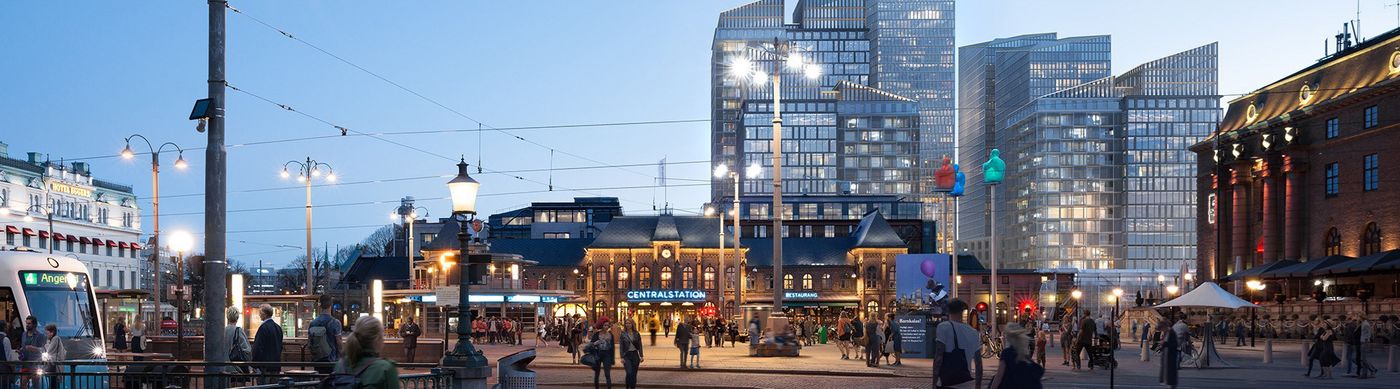 Visionsbild av drottningtorget kvällstid med stora glasbyggnader bakom centralstationen.