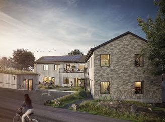 En byggnad med grå tegelfasad för  personer med funktionsnedsättning.