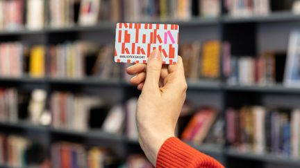 Hand som håller upp bibliotekskort