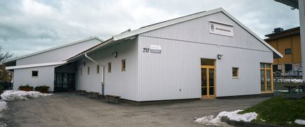 Hinnebäcksskolans huvudbyggnad med en skylt i bakgrunden.