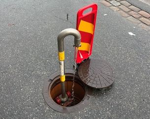 En vattenpost som består av ett rör som monterats på en brandpost i gatan. 