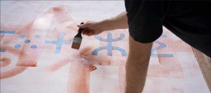 A person creating an artwork with a brush 
