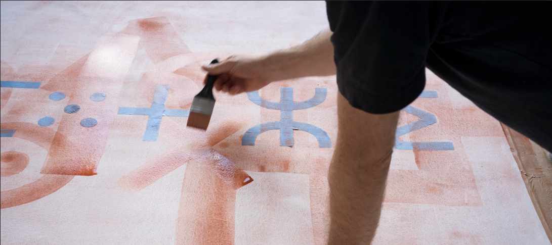 A person creating an artwork with a brush 