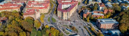 Drönarbild över Linneplatsen med vägar, hus och slottsskogen till vänster