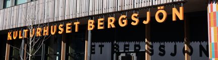 g Ett foto av en fasad med texten Kulturhuset Bergsjön i orange färg.