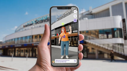 En telefon med en avatar i som visar vägen till en arena
