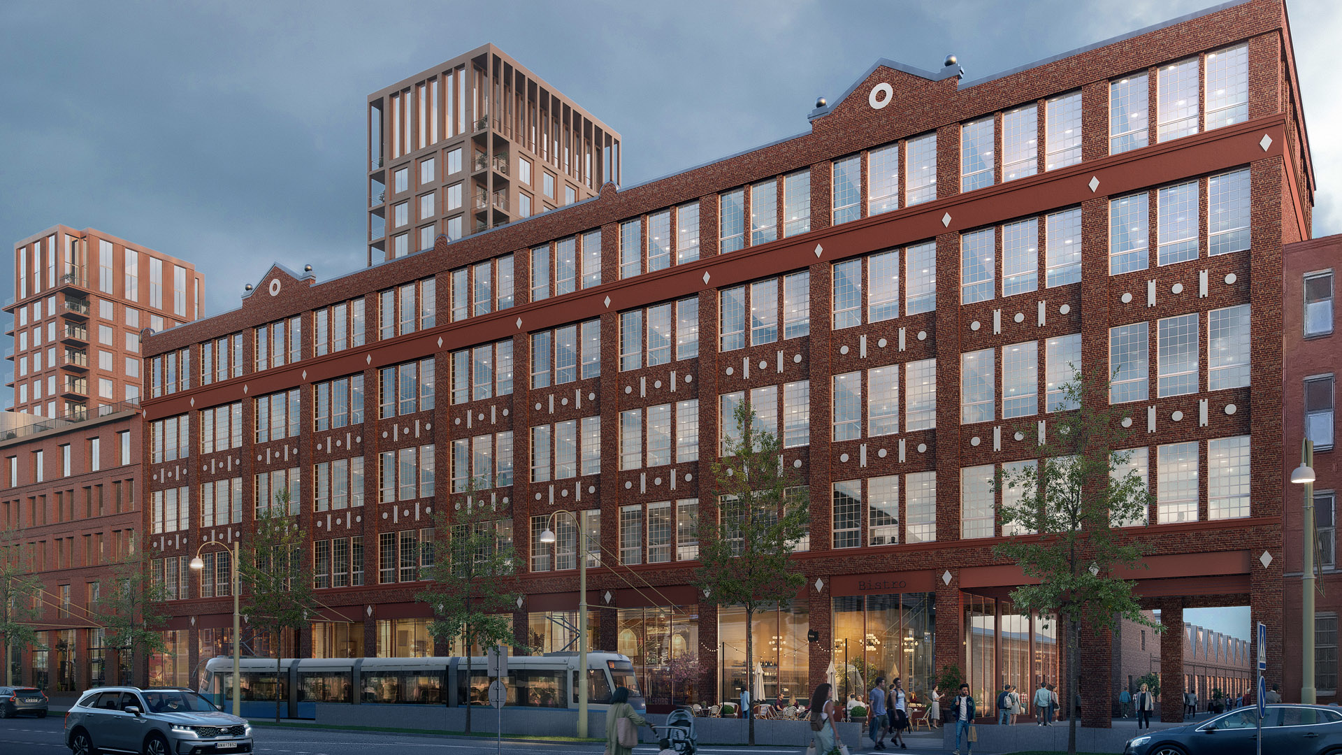 Bild på tegelfasader med många fönster i en igenkännlig industriell stil, sett från gatan.