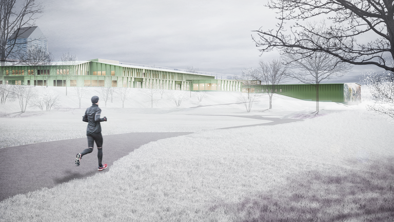En grön skolbyggnad och idrottshall sträcker sig över horisonten i ett vitt vinterlandskap. En joggare springer på en gångväg i förgrunden.