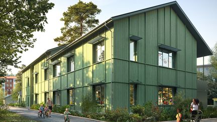 En tvåvåningsbyggnad med grönmålad träfasad.