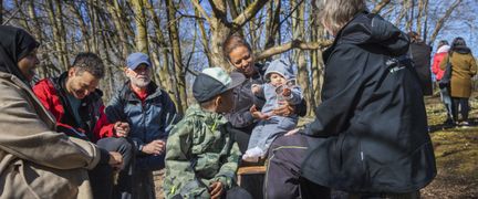 Människor i olika åldrar som sitter utomhus i solen