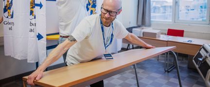 Person som lyfter ett bord.