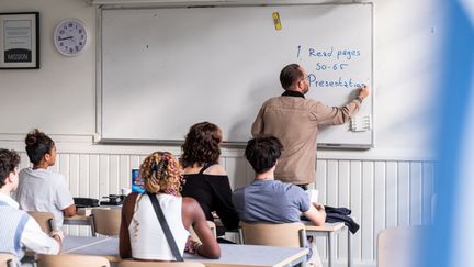 Teacher and students in a classroom.